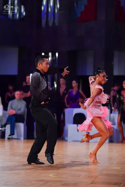 Dancesport competitor: Male dancer: black long-sleeved shirt with silver sequins on the shoulder and bl