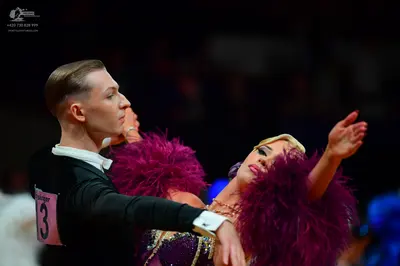 Dancesport competitor: Male dancer: black long-sleeved shirt with a white collar