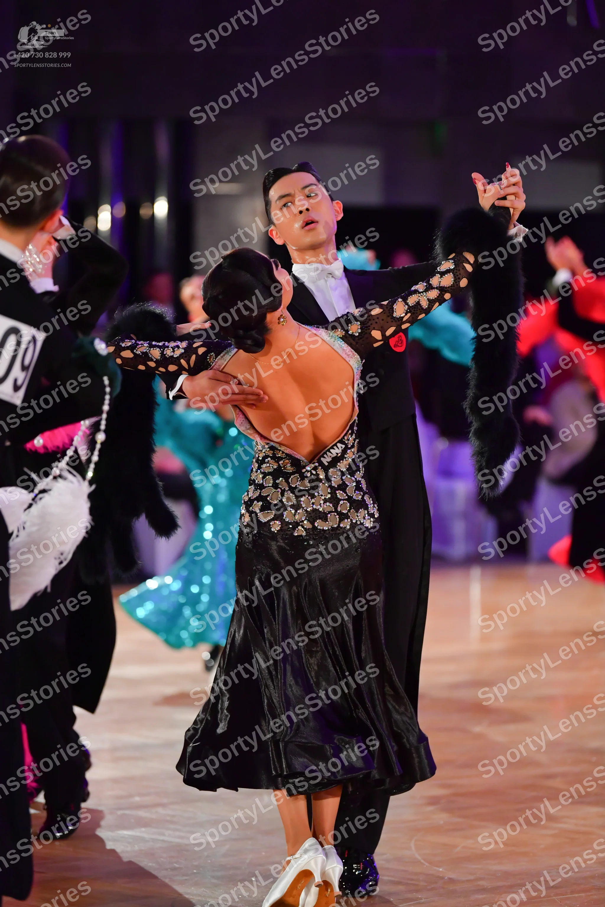 Dancesport competitor #09: Male dancer (center): black suit with a white shirt