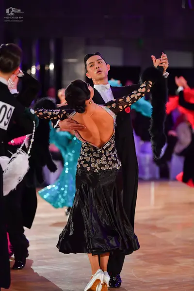 Dancesport competitor #09: Male dancer (center): black suit with a white shirt