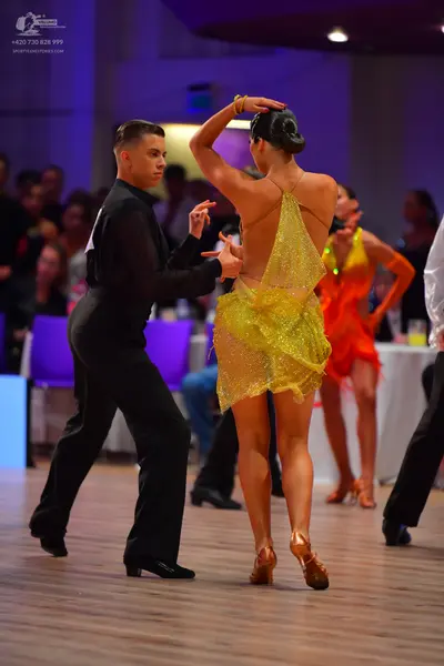 Dancesport competitor: Male dancer: black long-sleeved shirt and black trousers