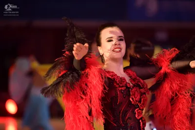 Dancesport competitor: Female dancer: red and black latin dance dress with red floral appliques, black 