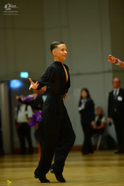Dancesport competitor: Male dancer: black long-sleeved shirt and black trousers