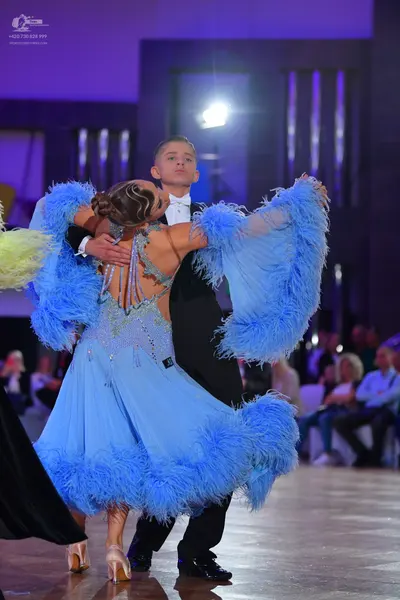 Dancesport competitor: Male dancer: black suit with a white shirt and white bowtie