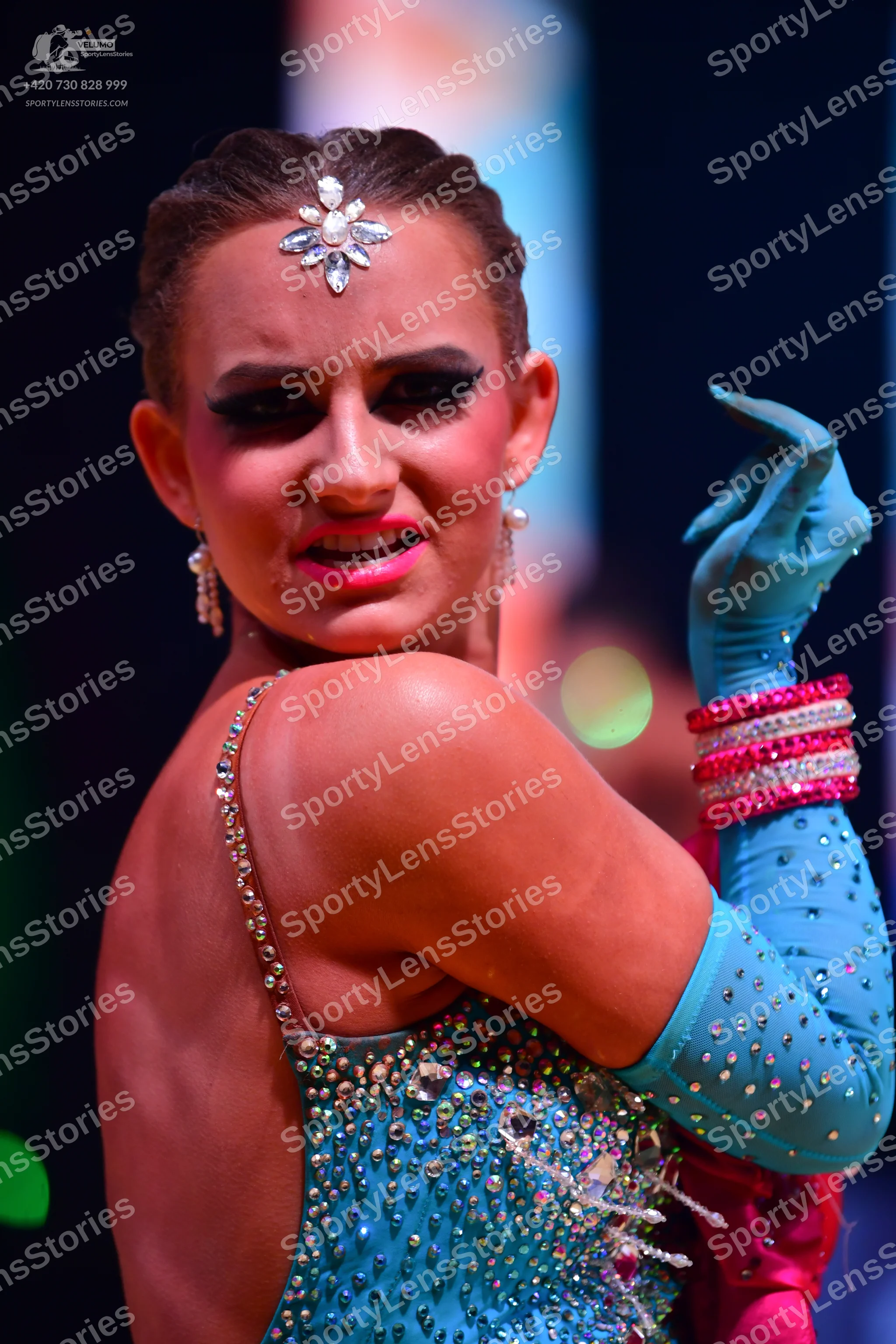 Dancesport competitor: Female dancer: light blue latin costume with sequins and rhinestones, matching l