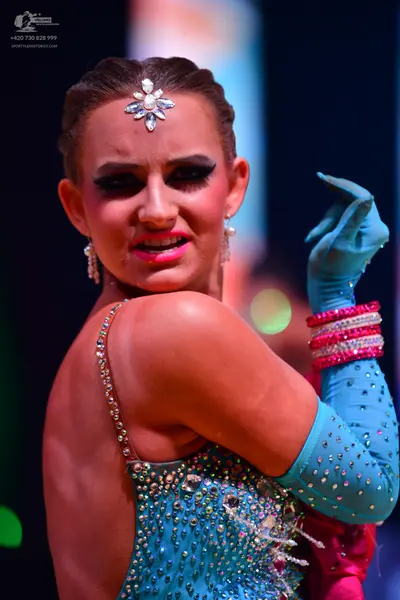 Dancesport competitor: Female dancer: light blue latin costume with sequins and rhinestones, matching l