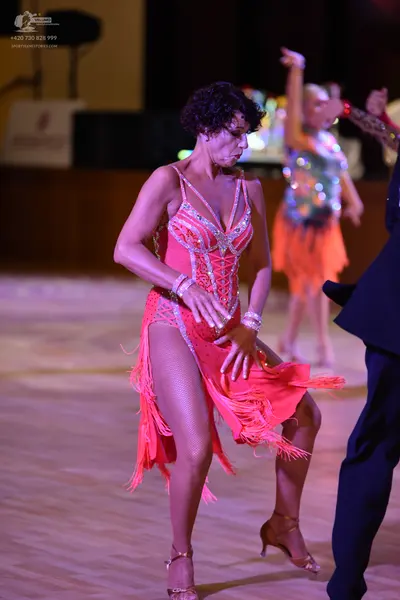 Dancesport competitor: ** Red Latin Dress
*   **Color:** Vibrant Red
*   **Fabric:** Satin (likely) wit