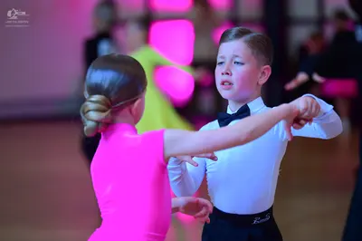 Dancesport competitor: Male dancer: white long-sleeved shirt, black bow tie, and black trousers