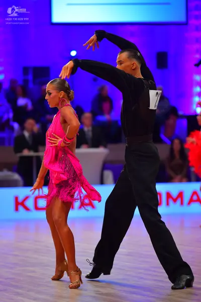 Dancesport competitor: Male dancer: black long-sleeved shirt and black trousers