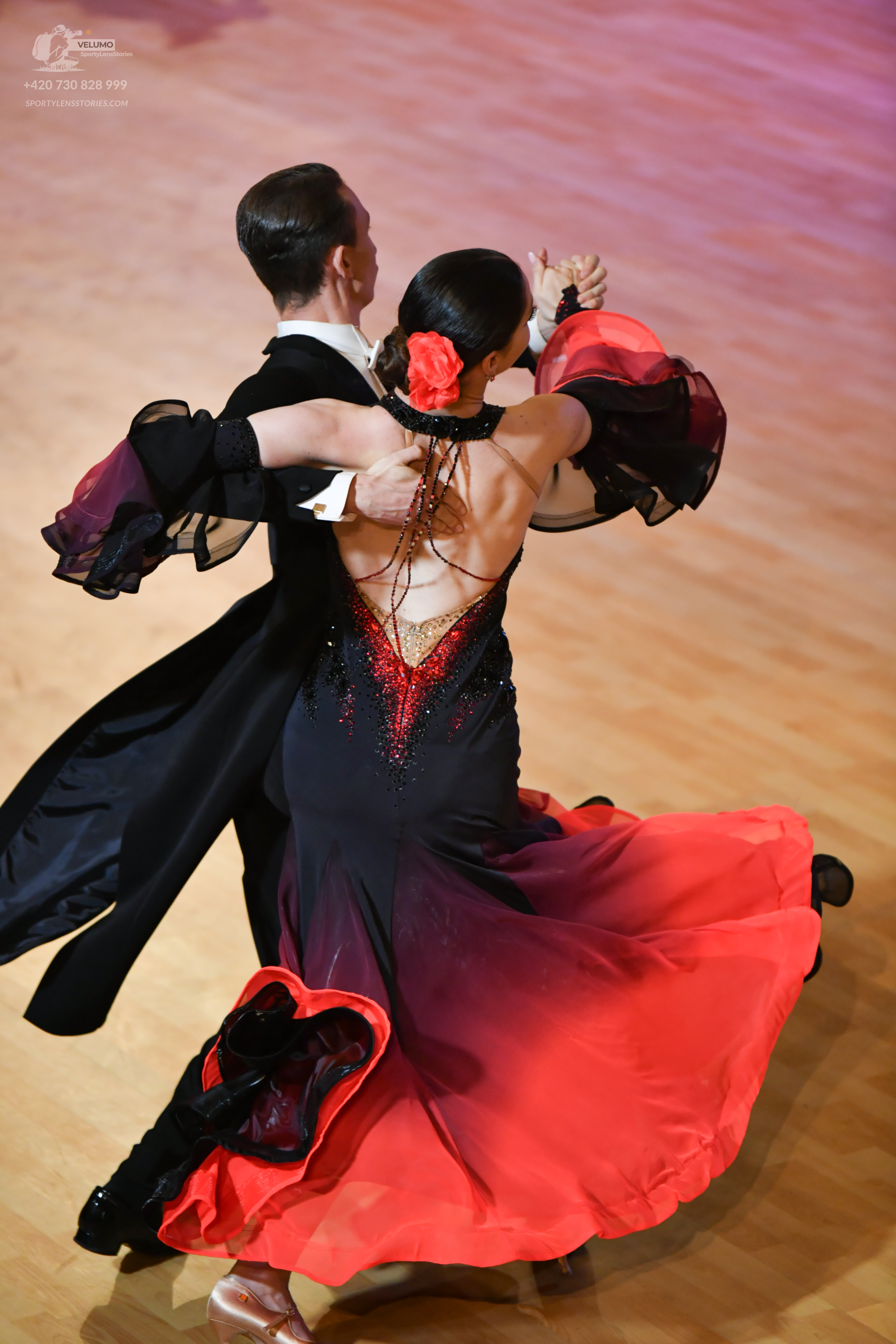 Dancesport competitor: ** Male: Black ballroom suit with sequined lapels and a subtle sheen fabric