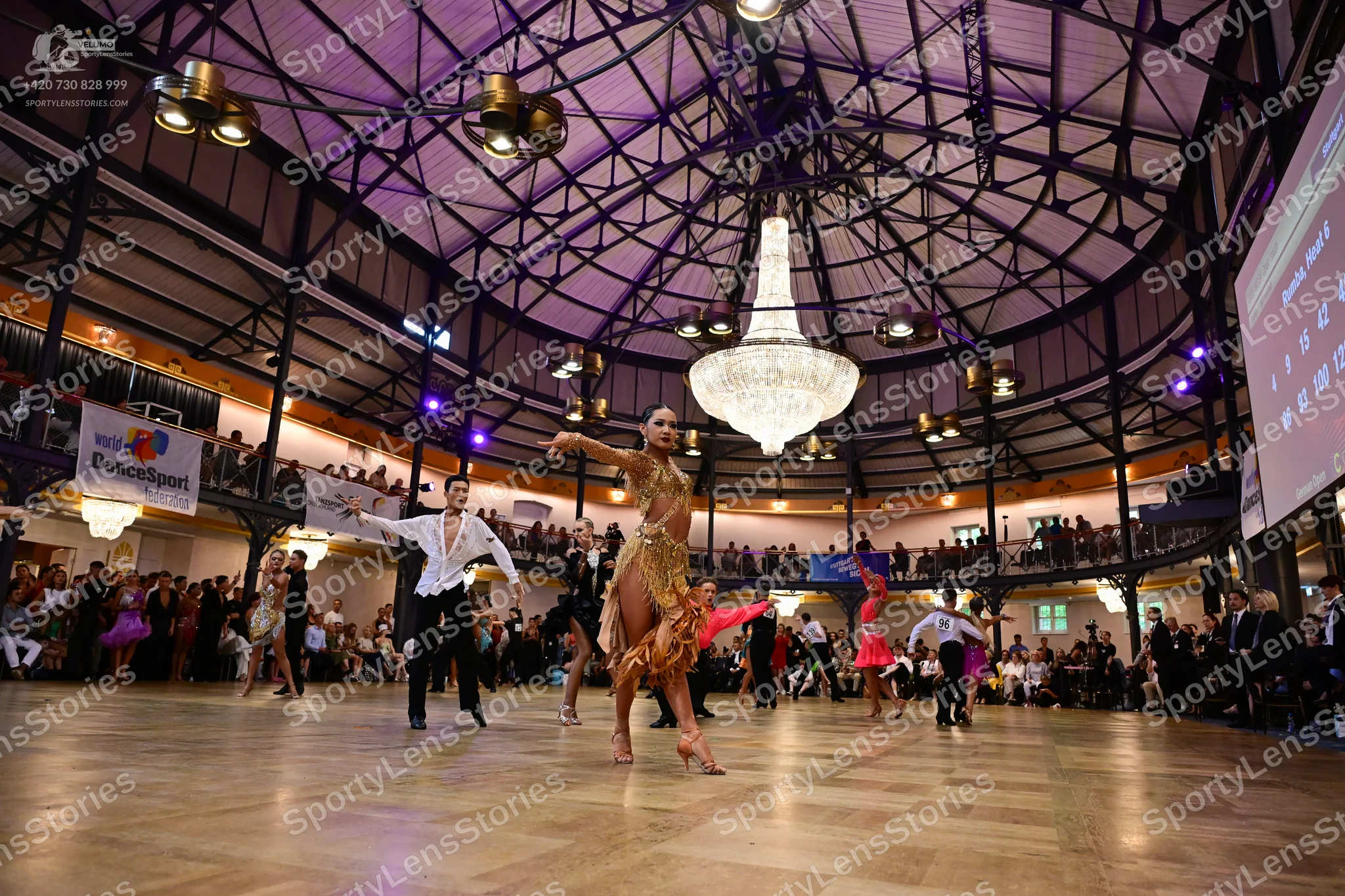Dancesport competitor: Central female dancer: gold sequined latin dress with fringe and embellishments