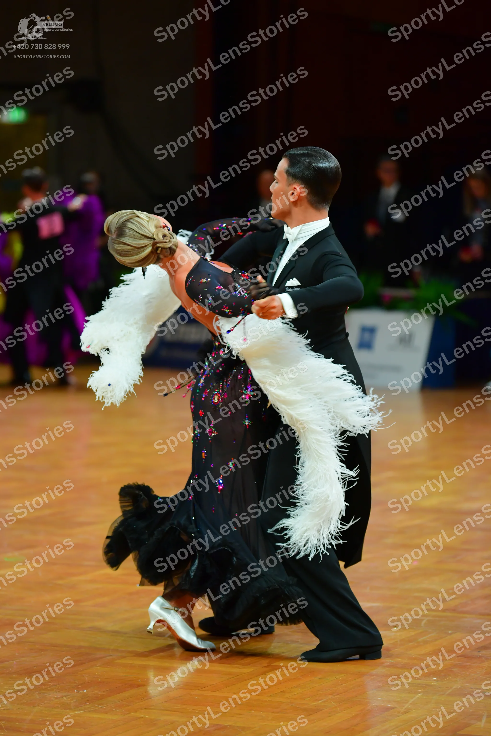 Dancesport competitor: Male dancer: black suit with a white shirt and a dark tie