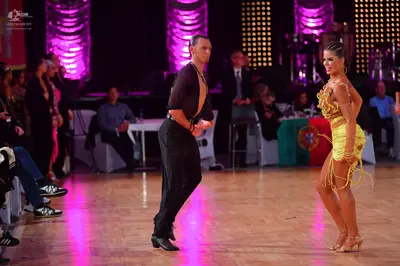 Dancesport competitor: Male dancer: black long-sleeved Latin shirt and black trousers