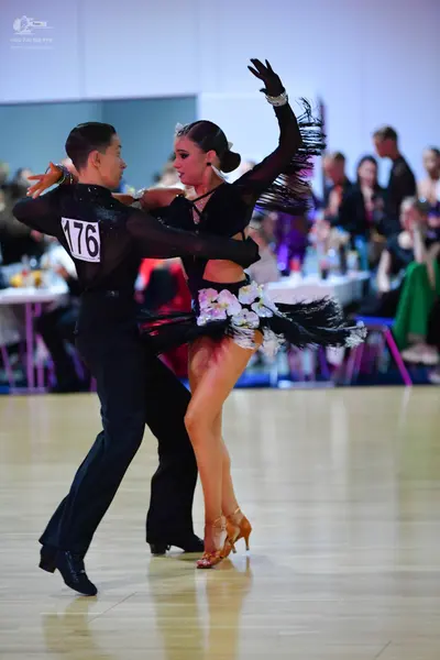 Dancesport competitor #176: Male dancer: black long-sleeved shirt and black trousers