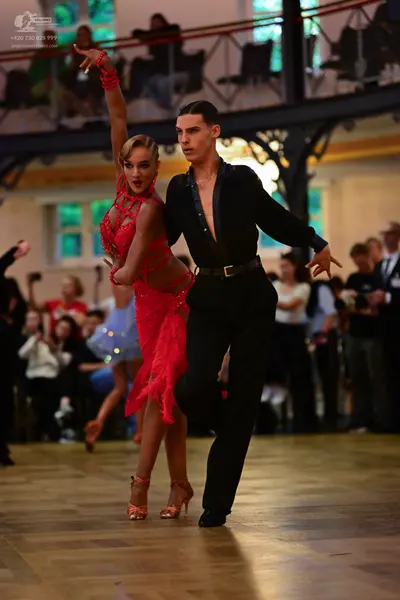 Dancesport competitor: Female dancer: red lace latin dress with a high neck and asymmetrical hemline, p