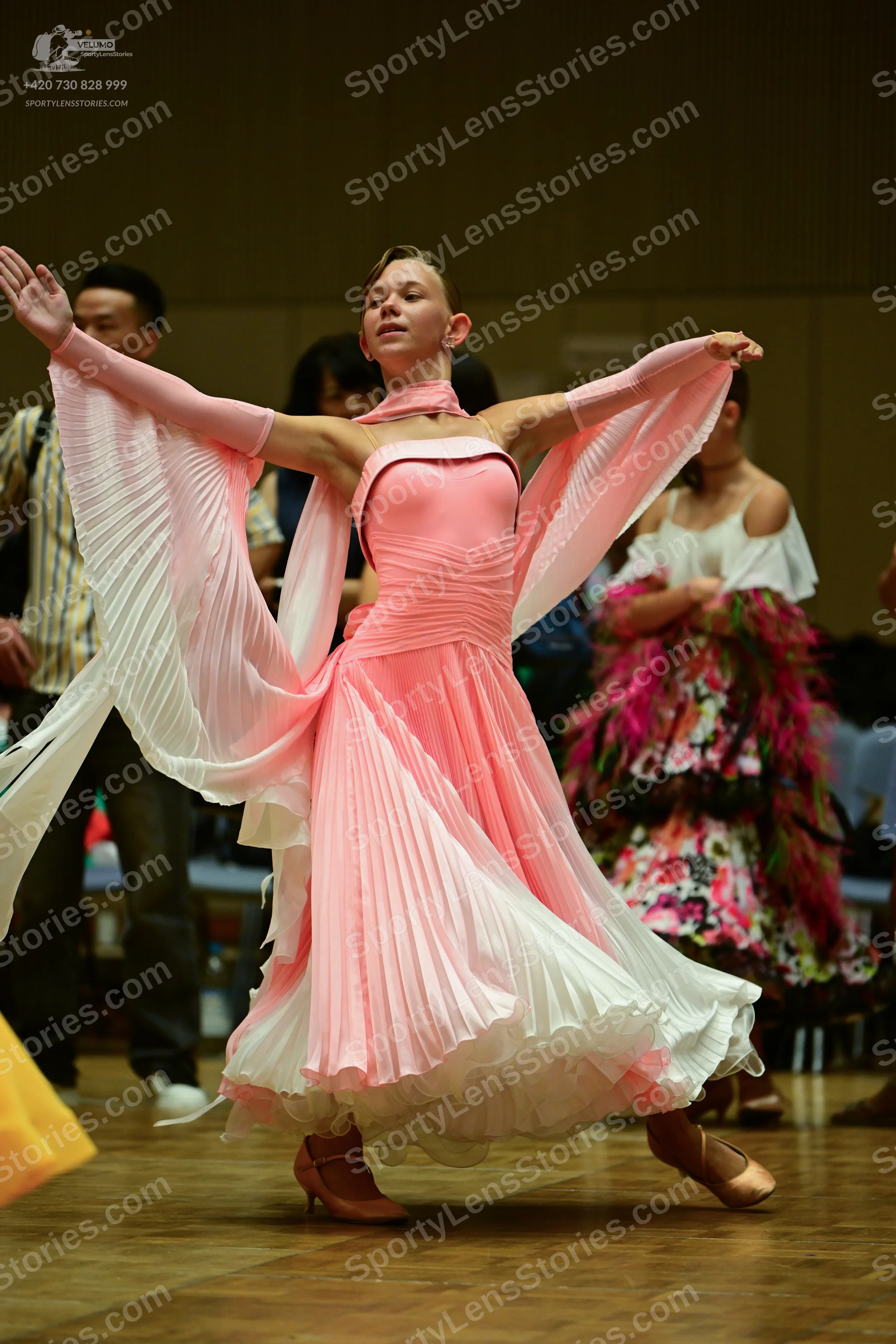 Dancesport competitor: ** White and Pink Ballgown
*   **Color:** Predominantly white with layered pink 