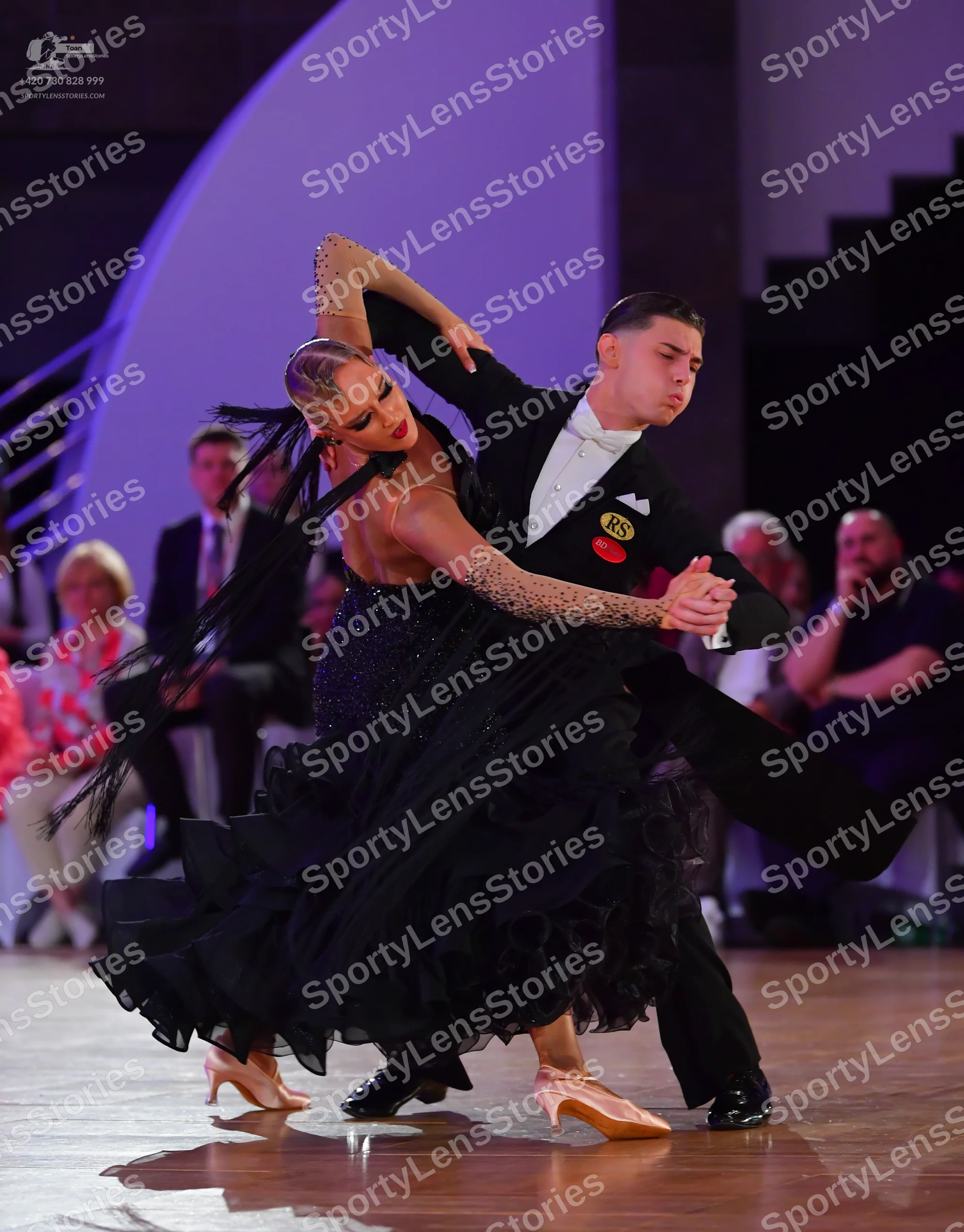 Dancesport competitor: Male dancer: black suit, white shirt, and black bowtie