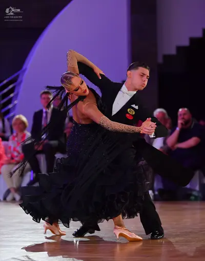 Dancesport competitor: Male dancer: black suit, white shirt, and black bowtie