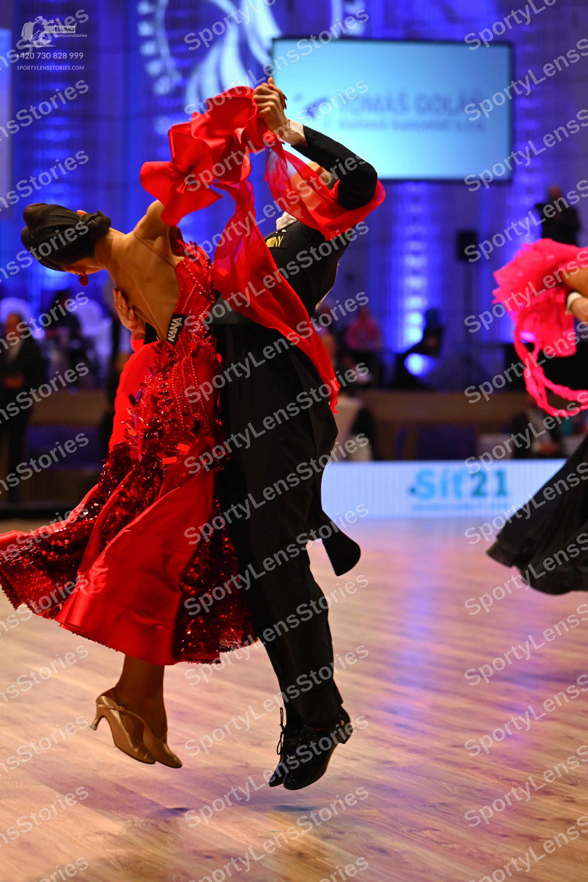 Dancesport competitor: Female dancer: red latin dress with satin-like fabric, red sequins on the skirt,