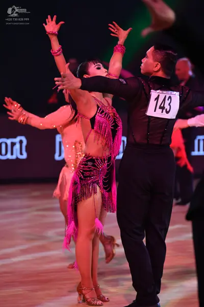 Dancesport competitor: Male dancer: black long-sleeved shirt and black trousers
