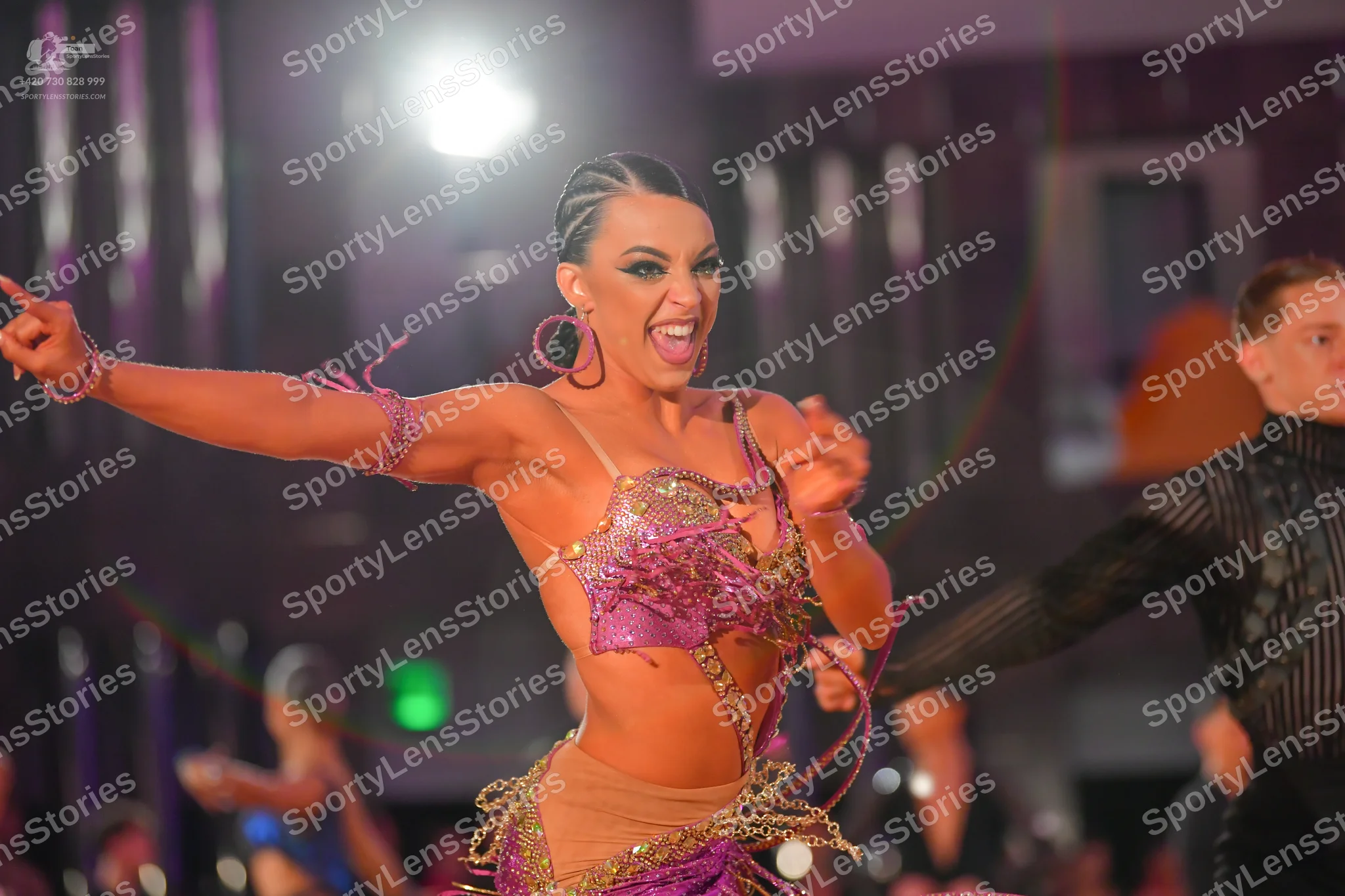 Dancesport competitor: Female dancer: pink and purple latin dance costume with sequins, intricate metal