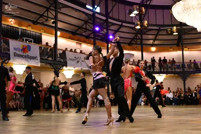 Dancesport competitor: Central female dancer: black and white Latin dance dress with sequin details