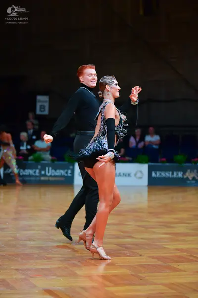 Dancesport competitor: Male dancer: black long-sleeved shirt and black trousers
