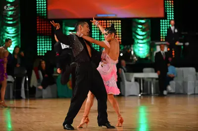 Dancesport competitor: Male dancer: black long-sleeved shirt with sequins and black trousers