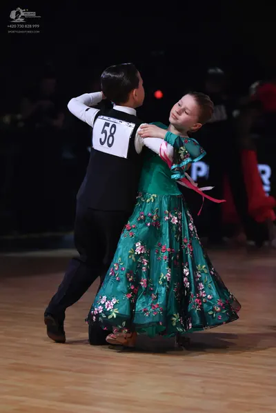 Dancesport competitor: Male dancer: black vest over a white long-sleeved shirt and black trousers
