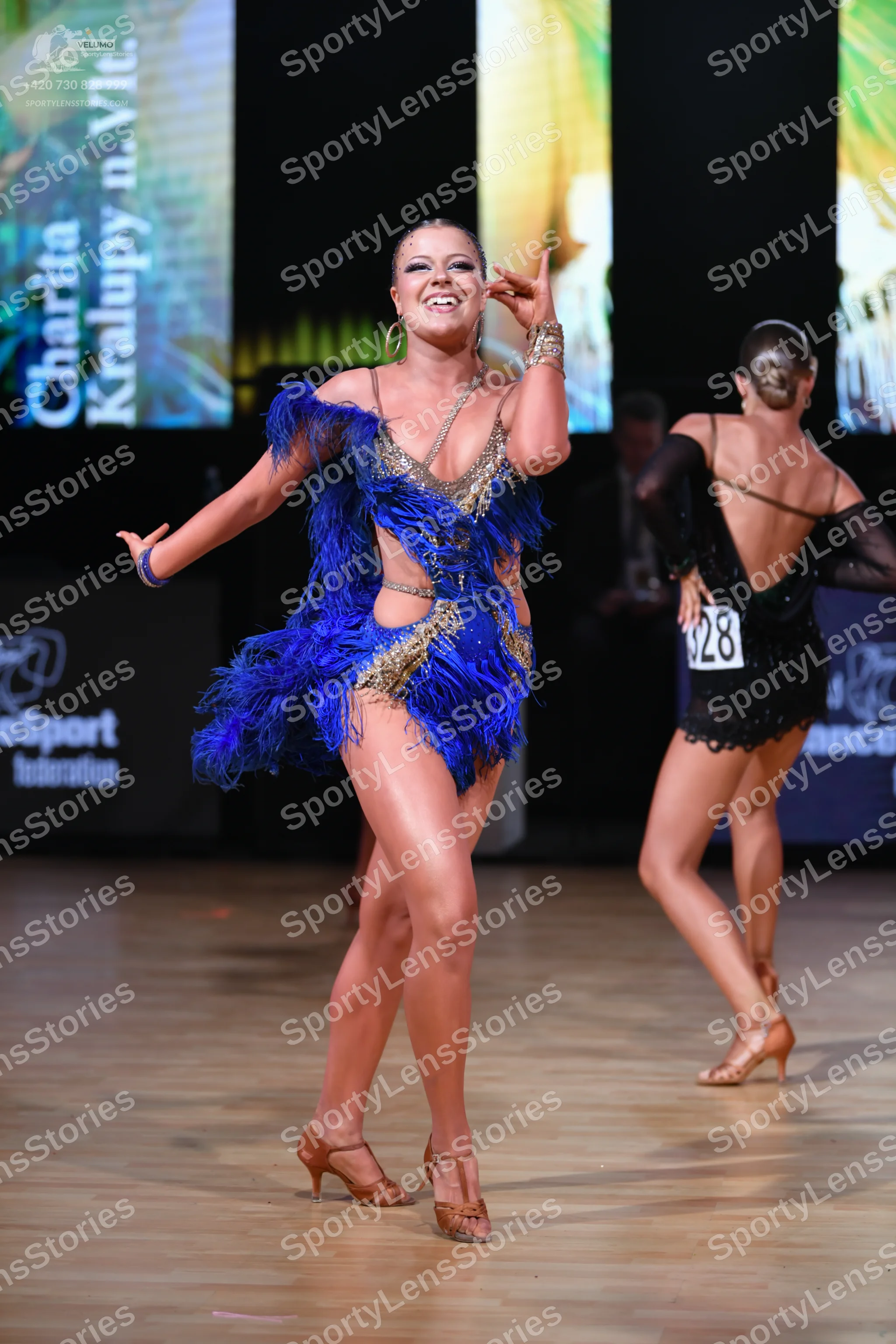 Dancesport competitor: Female dancer: blue and gold latin dress with fringe and sequins