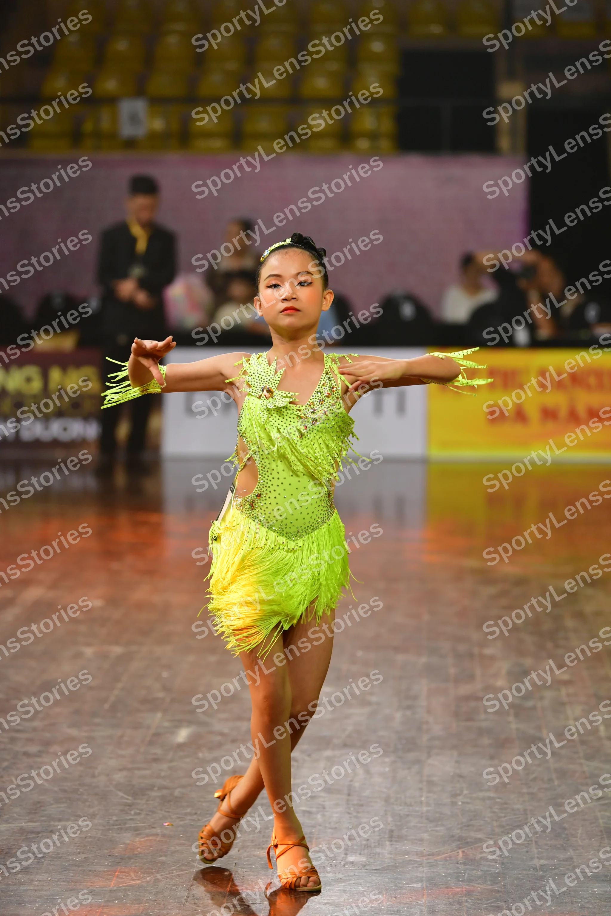 Dancesport competitor: Female dancer: lime green latin dress with sequins and fringe, matching lime gre