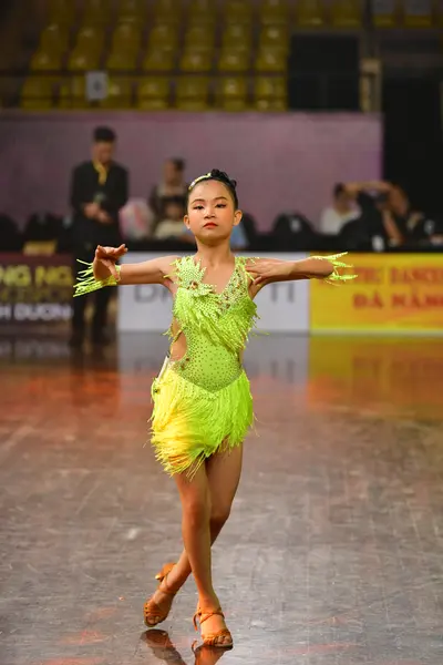 Dancesport competitor: Female dancer: lime green latin dress with sequins and fringe, matching lime gre