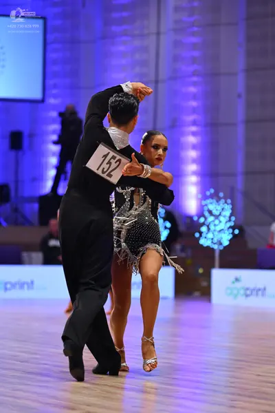 Dancesport competitor: Male dancer: black suit with a white collar