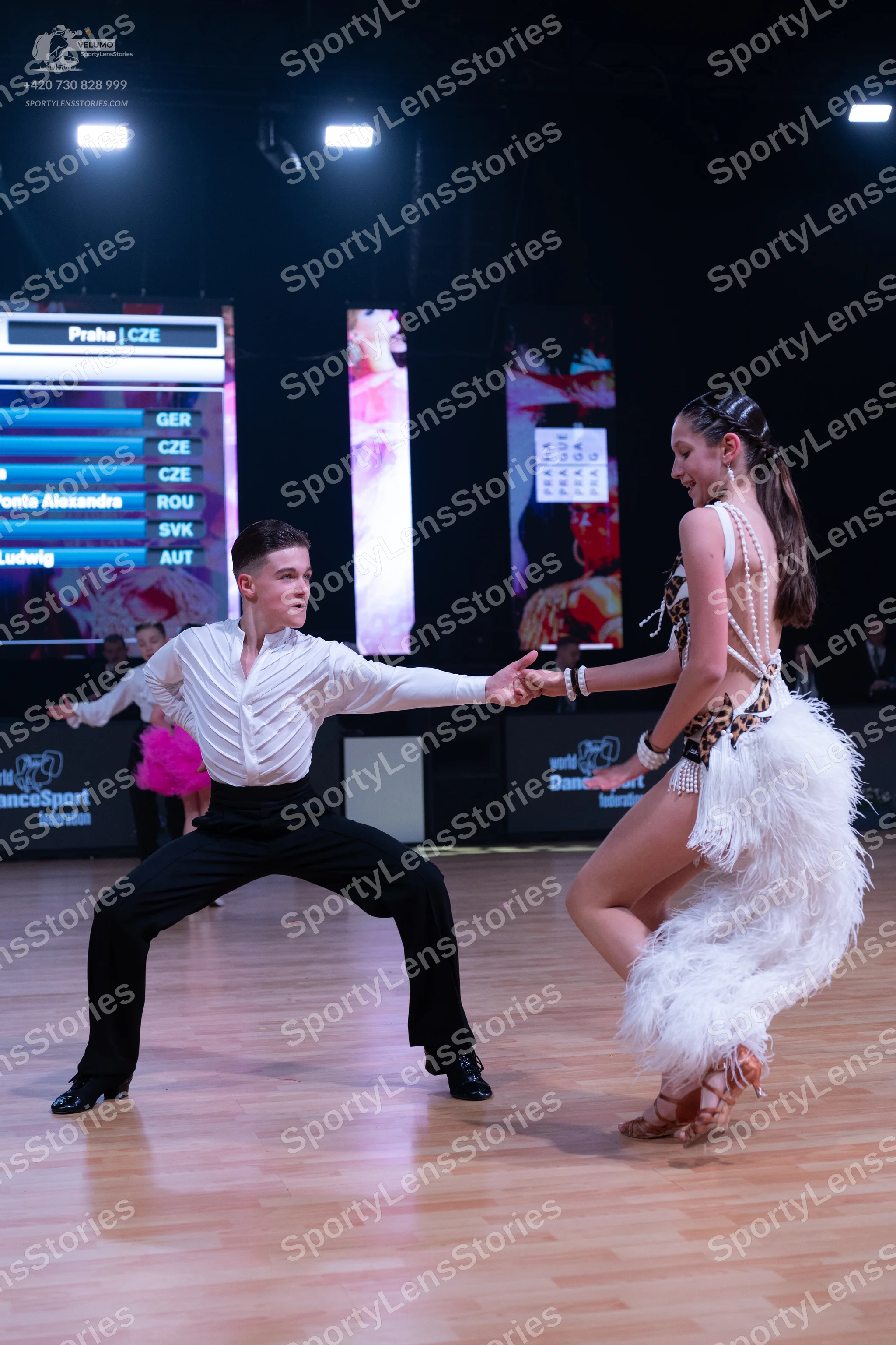 Dancesport competitor: Male dancer: white long-sleeved shirt with a textured, pleated front and black t
