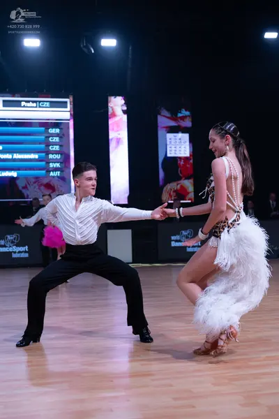 Dancesport competitor: Male dancer: white long-sleeved shirt with a textured, pleated front and black t