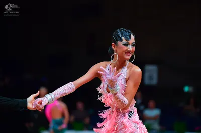 Dancesport competitor: Main female dancer: light pink/lavender latin dress with heavy sequin/crystal em