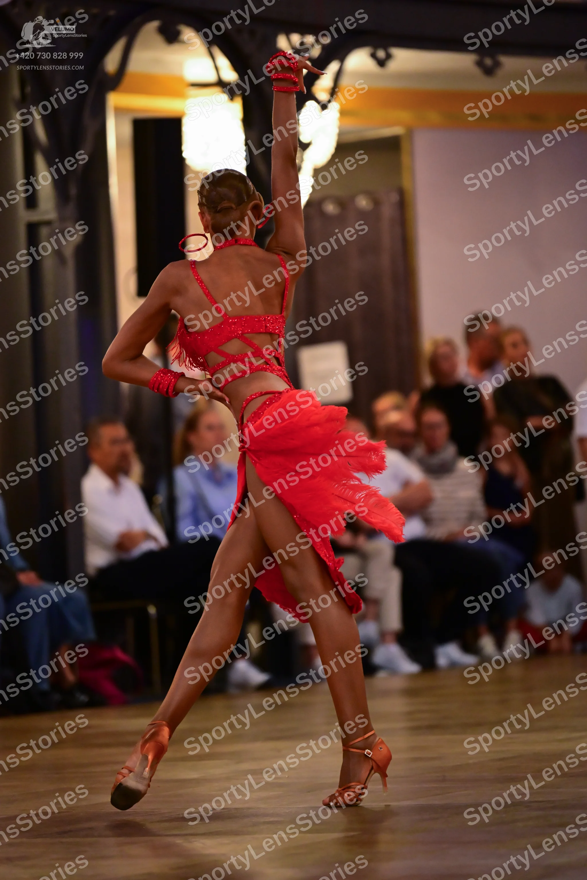 Dancesport competitor: Female dancer: red latin dress with lace and a ruffled skirt