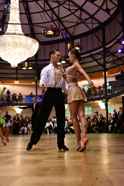 Dancesport competitor: Male dancer: white long-sleeved shirt and black trousers