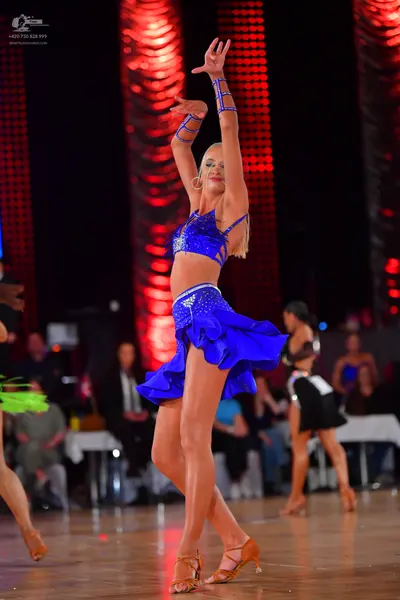 Dancesport competitor: Main female dancer: blue two-piece latin dress with silver sequins and matching 