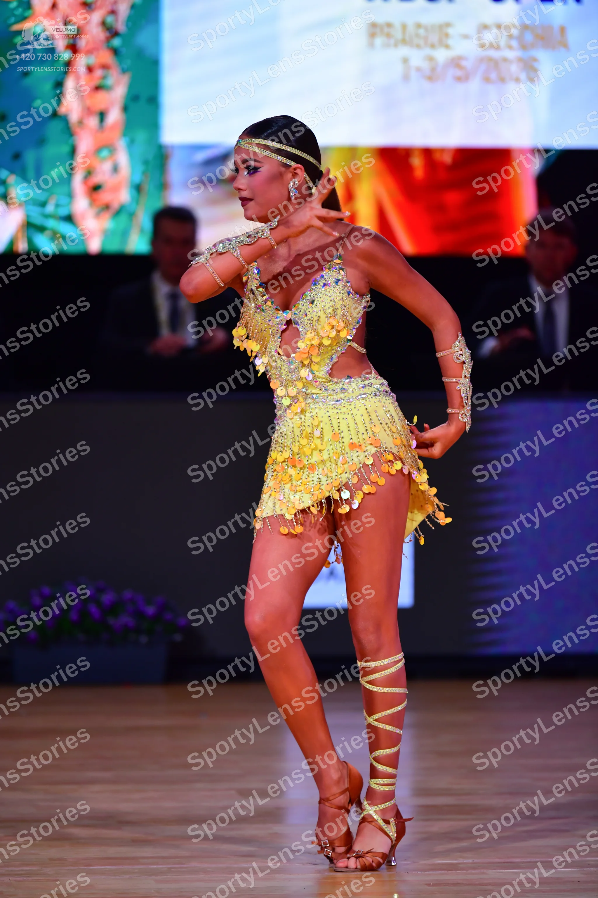 Dancesport competitor: Female dancer: light yellow Latin dance dress covered in sequins and fringe with