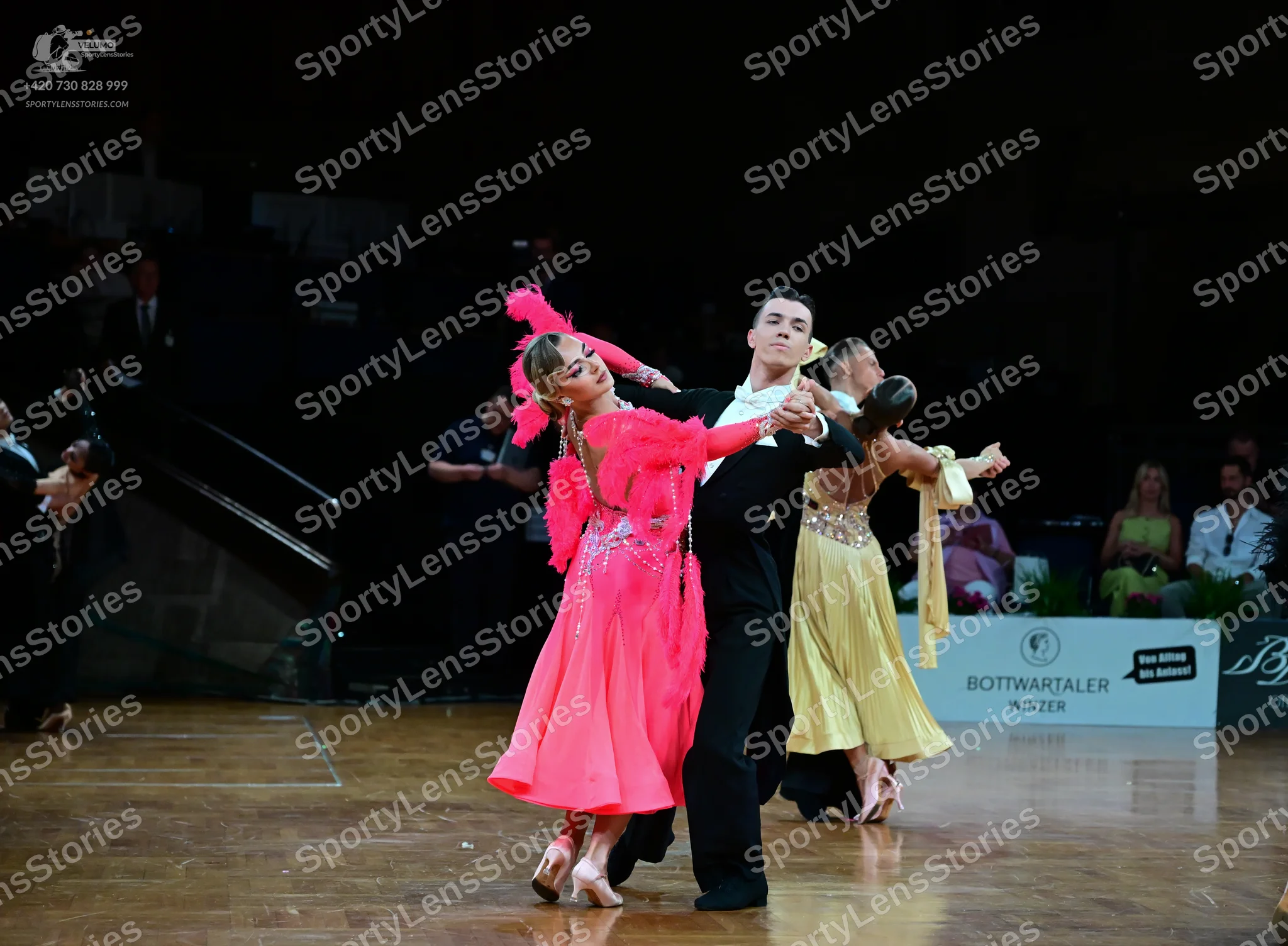 Dancesport competitor: Main female dancer: pink latin dress with a flowy skirt and sequined bodice