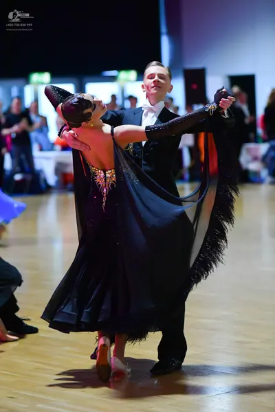 Dancesport competitor: Male dancer: black suit with a white shirt and white bowtie
