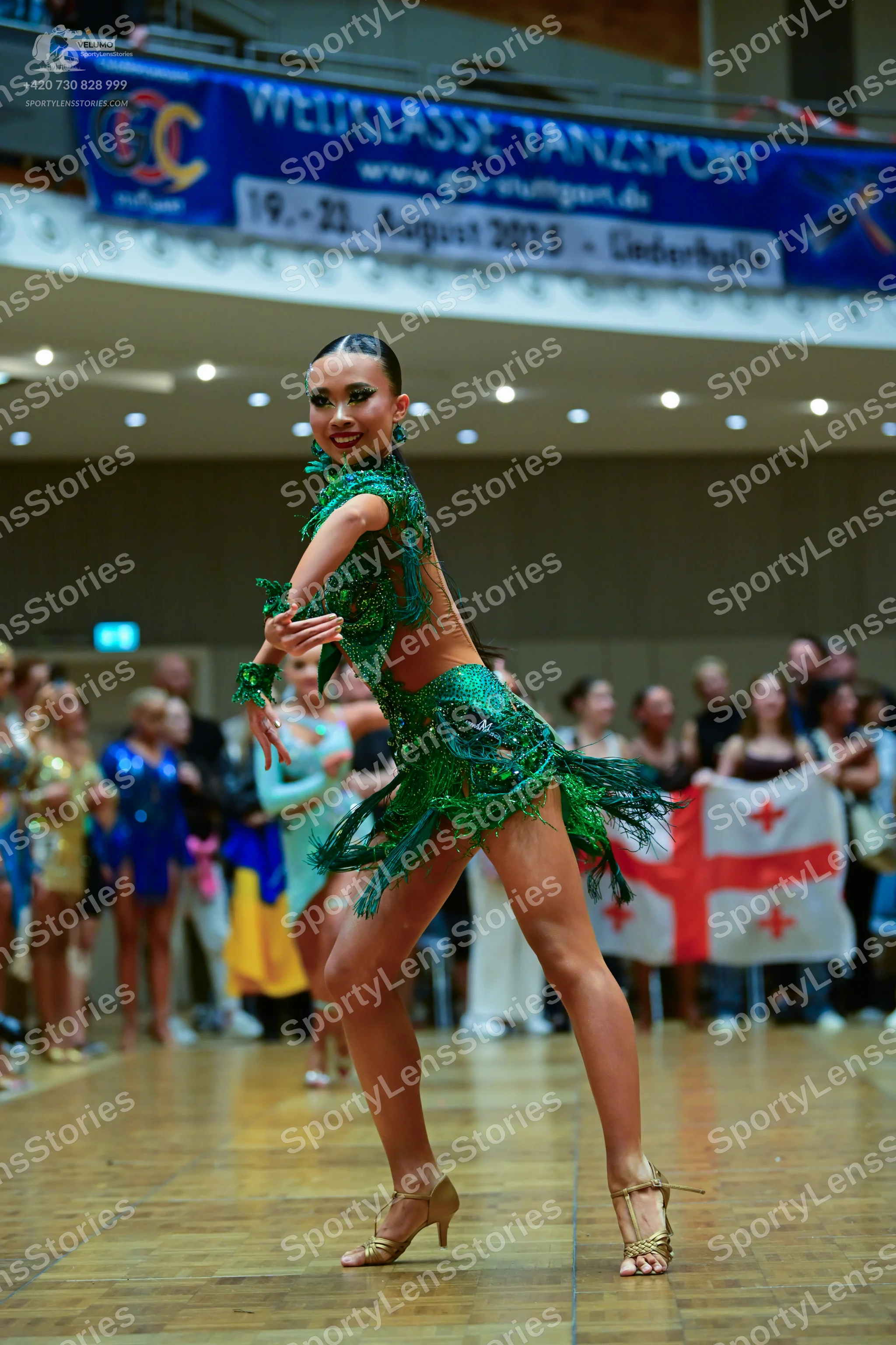 Dancesport competitor: Main female dancer: green Latin dance dress with heavy green sequin embellishmen