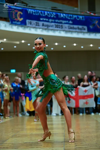 Dancesport competitor: Main female dancer: green Latin dance dress with heavy green sequin embellishmen