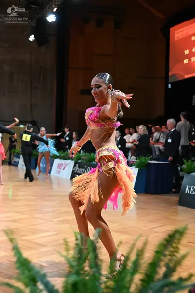 Dancesport competitor: Female dancer: pink and peach latin dress with sequins, lace, and peach fringe