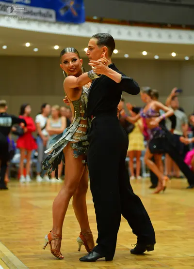 Dancesport competitor: Male dancer: black long-sleeved shirt and black trousers