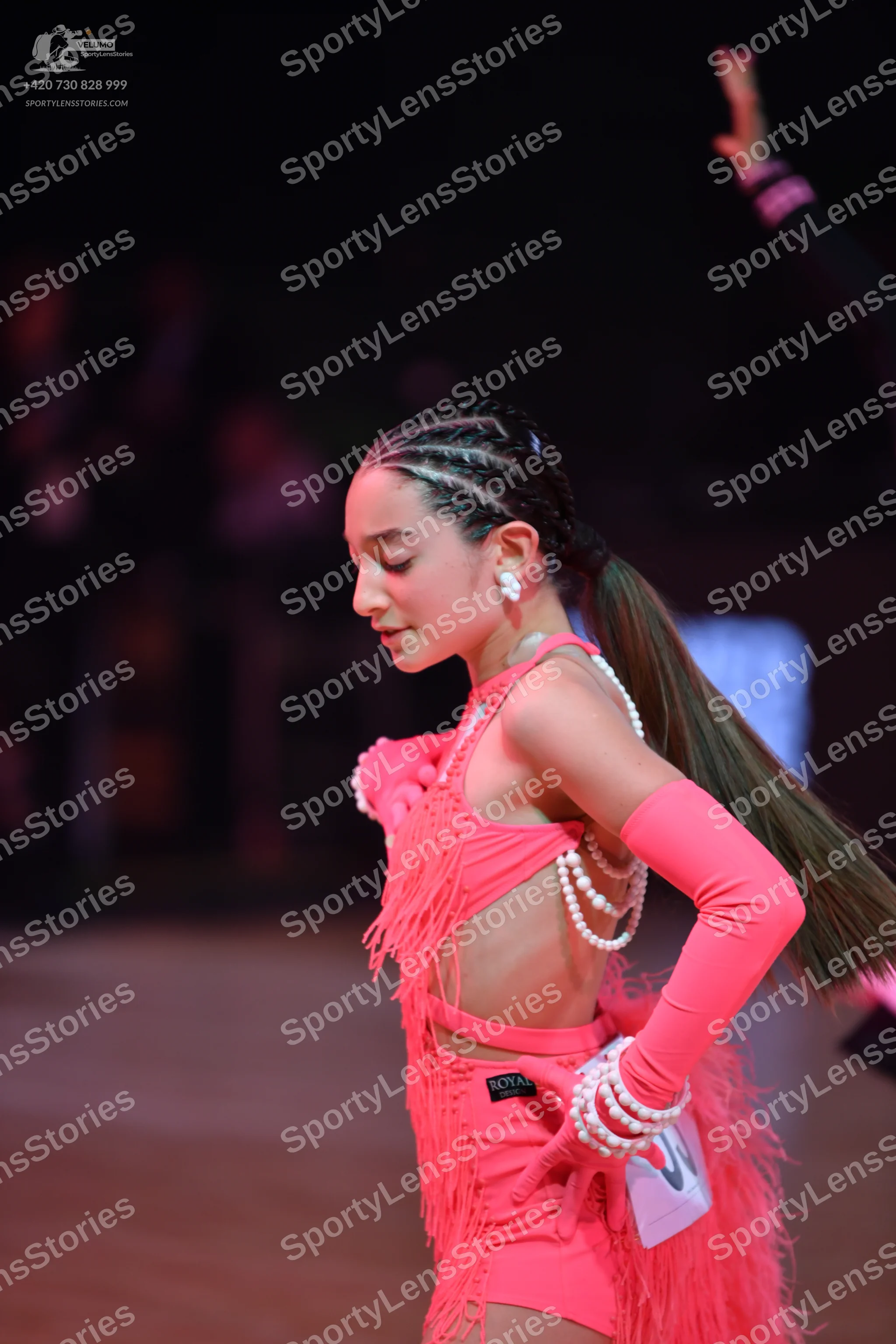 Dancesport competitor: Female dancer: pink Latin dance dress with long fringe, matching long sleeves, a