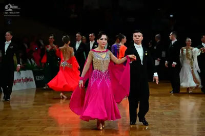 Dancesport competitor: Main female dancer: pink ballgown with a gold sequined and beaded bodice and lon