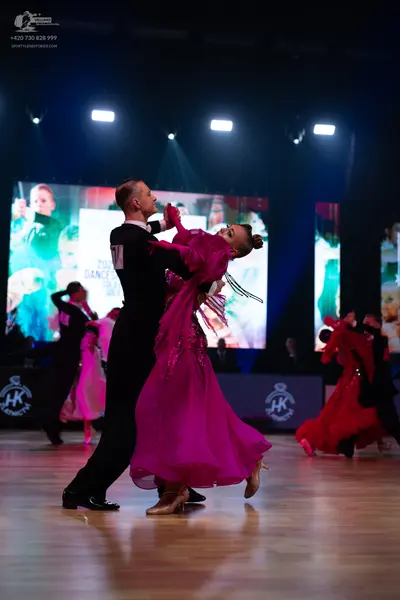 Dancesport competitor: Main male dancer: black suit, white shirt, and black bowtie