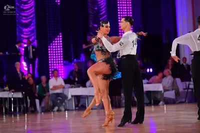 Dancesport competitor #14: Female dancer: blue and black Latin dance dress with sequins and fringe